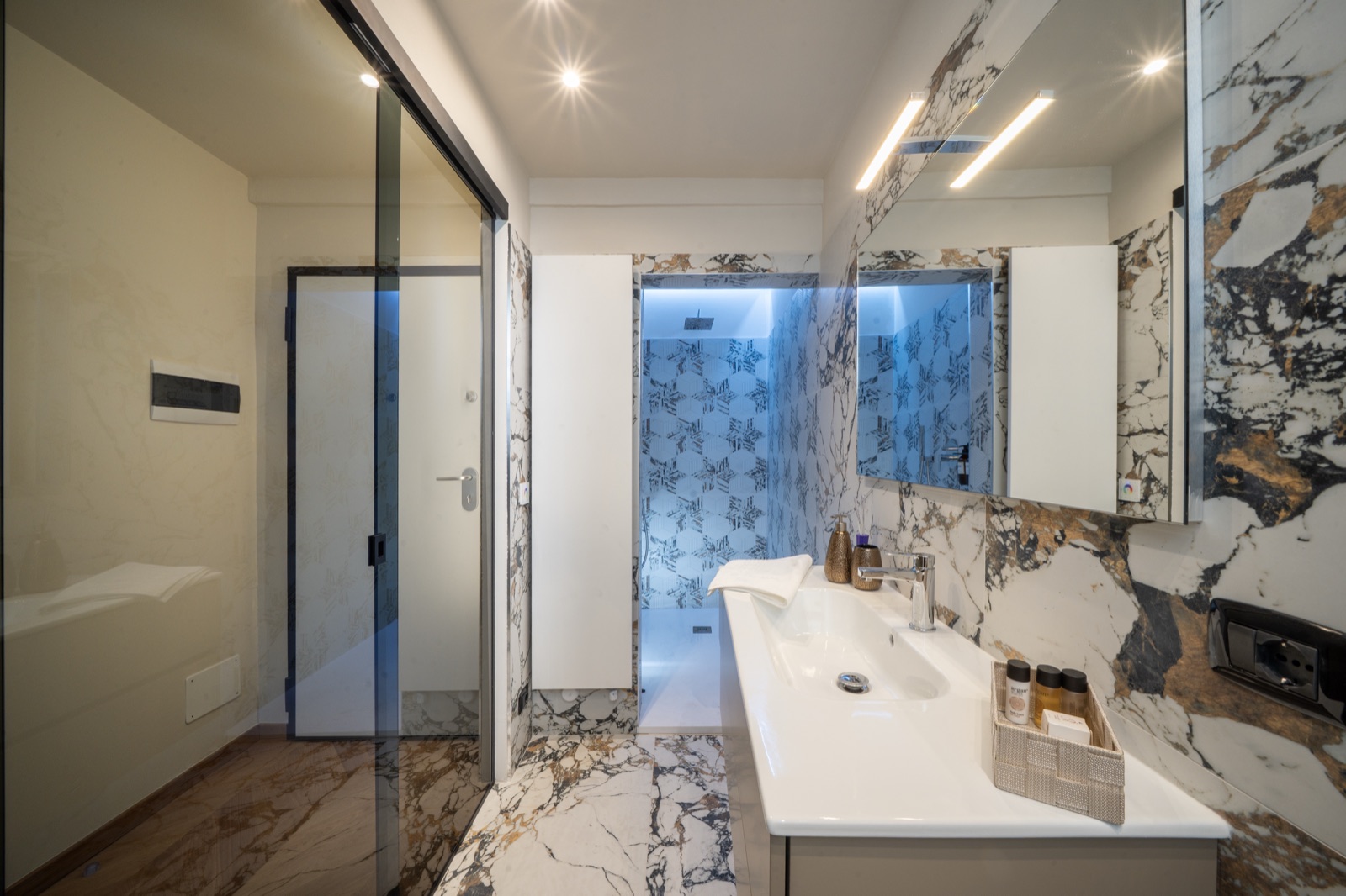 Il lavabo del bagno in marmo, con lo specchio illuminato